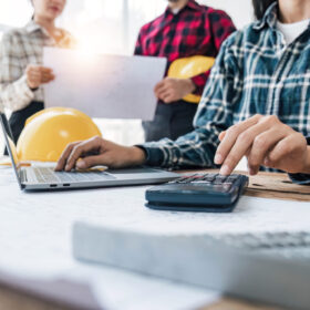 Civil engineer teams meeting working together wear worker helmets hardhat on construction site in modern city. Foreman industry project manager engineer teamwork. Asian industry professional team.